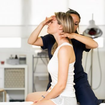 Physiotherapist inspecting her patient in a physiotherapy center